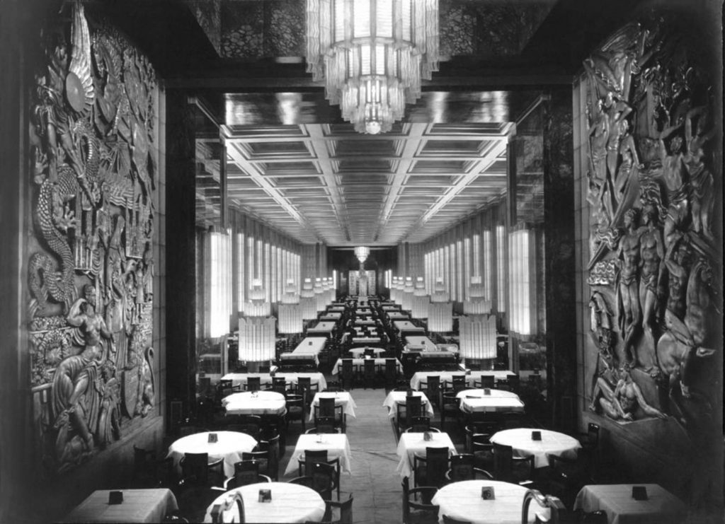Art Deco interior of the SS Normandie first-class dining room, 1935, showing lacquered wall panels, Lalique chandeliers, and geometric relief sculptures — the defining inspiration for Art Deco home interior design.